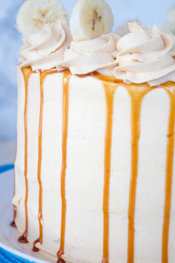 Moist and fluffy Banana cake, filled and frosted with creamy caramel buttercream, and topped with delicious homemade caramel sauce and sliced bananas. This Banana Caramel Layer Cake is the perfect dessert for birthdays, dinner parties, or any occasion!