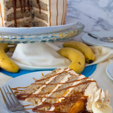 Moist and fluffy Banana cake, filled and frosted with creamy caramel buttercream, and topped with delicious homemade caramel sauce and sliced bananas. This Banana Caramel Layer Cake is the perfect dessert for birthdays, dinner parties, or any occasion!