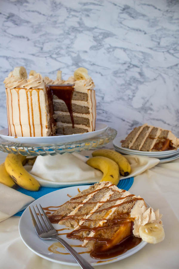 Moist and fluffy Banana cake, filled and frosted with creamy caramel buttercream, and topped with delicious homemade caramel sauce and sliced bananas. This Banana Caramel Layer Cake is the perfect dessert for birthdays, dinner parties, or any occasion!