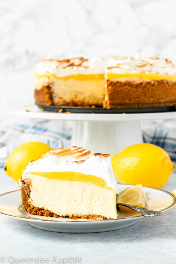 lemon meringue cheesecake with graham cracker crust, lemon cheesecake, lemon curd topping, meringue rosettes