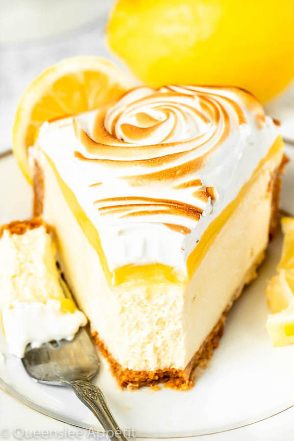 lemon meringue cheesecake with graham cracker crust, lemon cheesecake, lemon curd topping, meringue rosettes