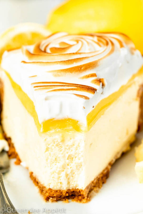 lemon meringue cheesecake with graham cracker crust, lemon cheesecake, lemon curd topping, meringue rosettes