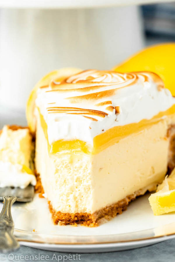 lemon meringue cheesecake with graham cracker crust, lemon cheesecake, lemon curd topping, meringue rosettes