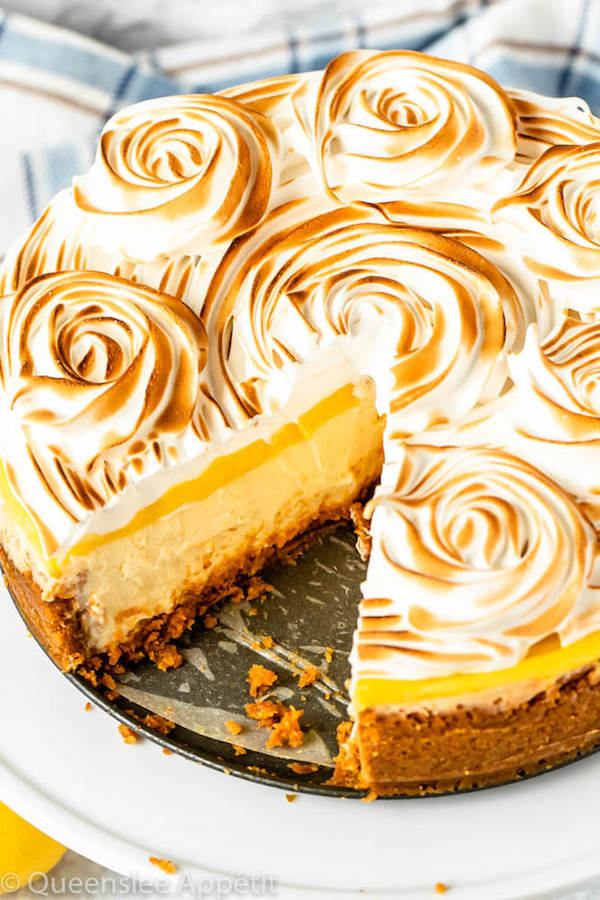 lemon meringue cheesecake with graham cracker crust, lemon cheesecake, lemon curd topping, meringue rosettes