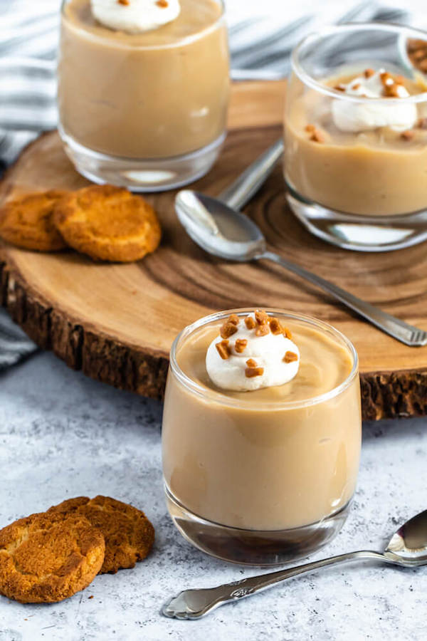 homemade butterscotch pudding topped with whipped cream and toffee bits