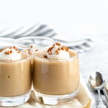 homemade butterscotch pudding topped with whipped cream and toffee bits