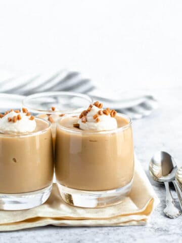 homemade butterscotch pudding topped with whipped cream and toffee bits