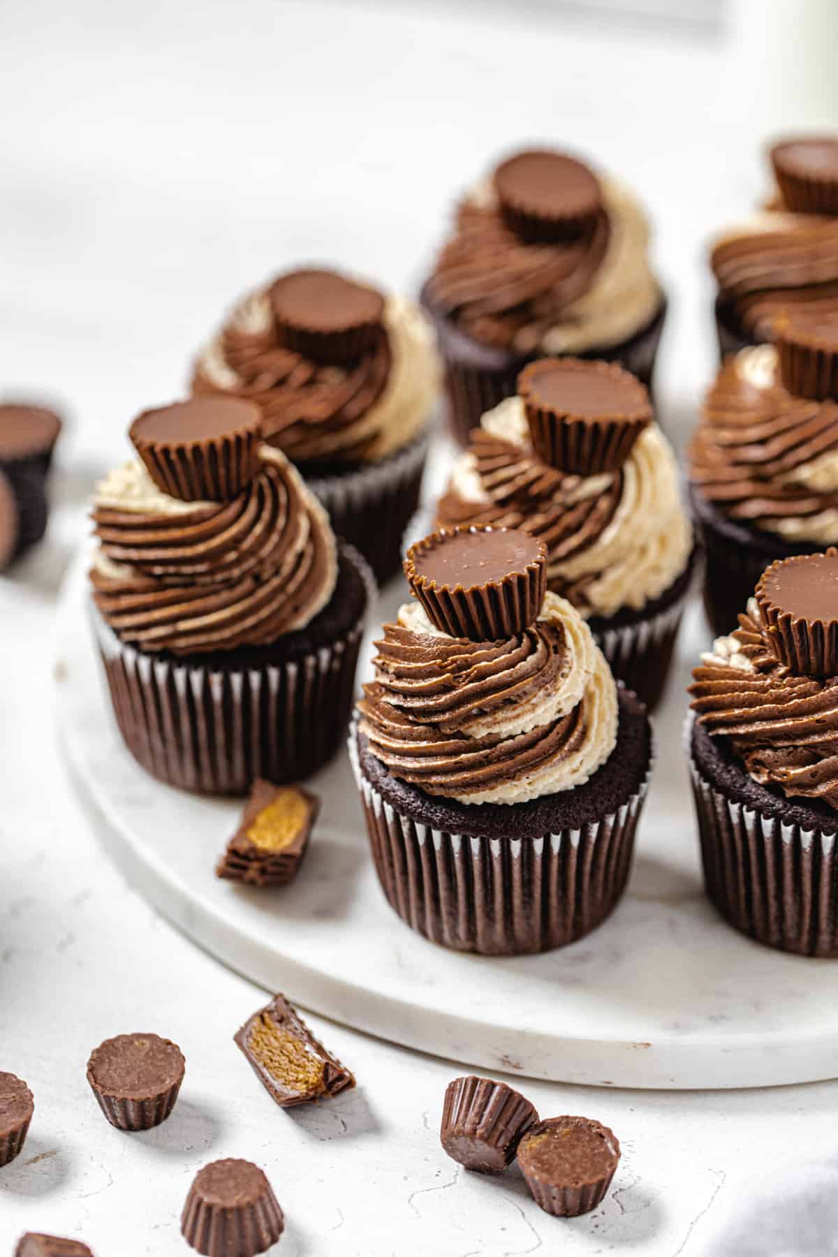 angled view of cupcakes on a round marble board