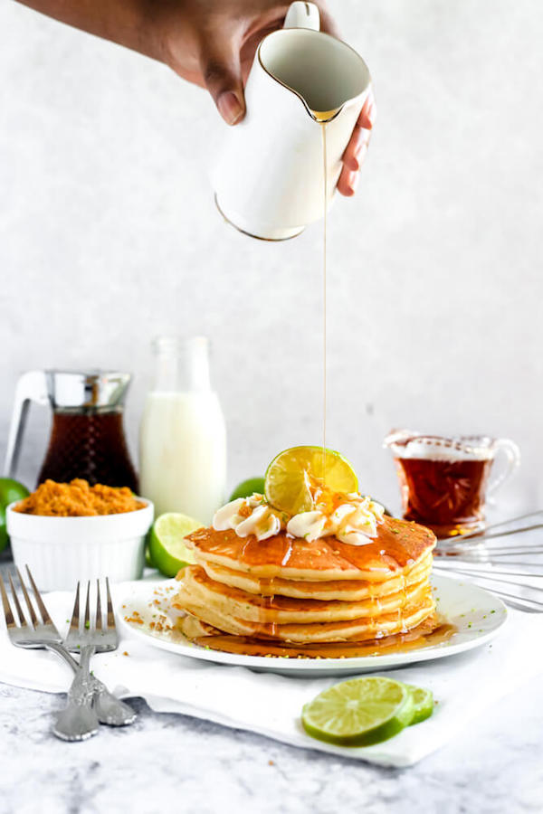 lime pancakes with whipped cream, graham cracker crumbs, lime zest and a lime twist on top