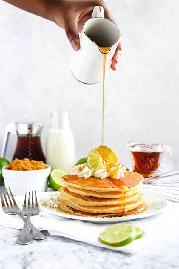 lime pancakes with whipped cream, graham cracker crumbs, lime zest and a lime twist on top