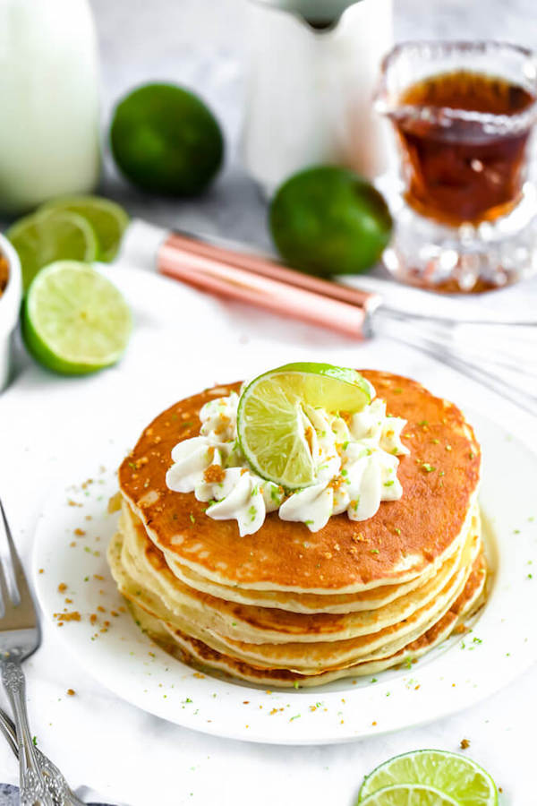 lime pancakes with whipped cream, graham cracker crumbs, lime zest and a lime twist on top