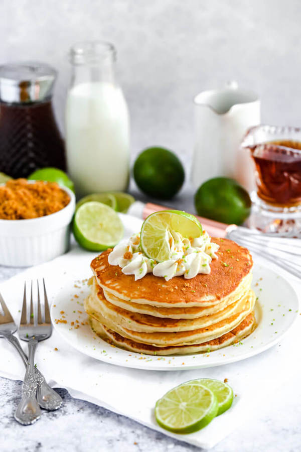 lime pancakes with whipped cream, graham cracker crumbs, lime zest and a lime twist on top