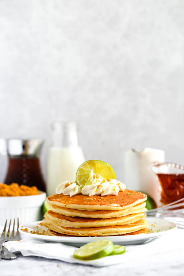 lime pancakes with whipped cream, graham cracker crumbs, lime zest and a lime twist on top