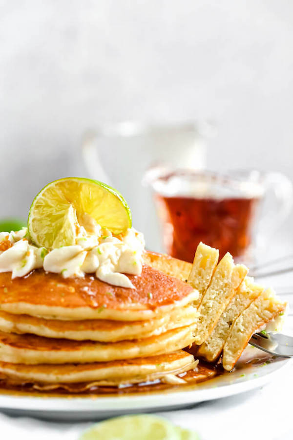 lime pancakes with whipped cream, graham cracker crumbs, lime zest and a lime twist on top