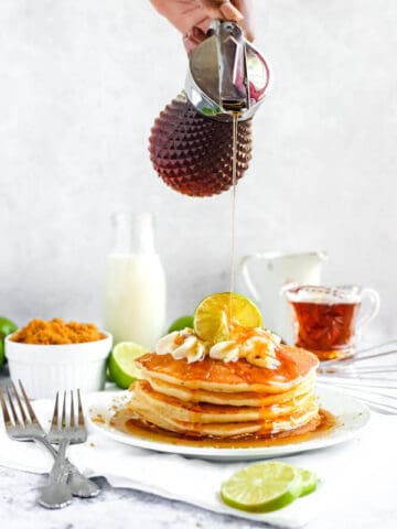 lime pancakes with whipped cream, graham cracker crumbs, lime zest and a lime twist on top