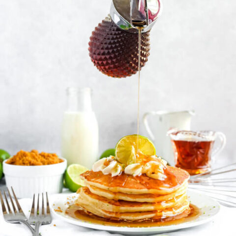 lime pancakes with whipped cream, graham cracker crumbs, lime zest and a lime twist on top