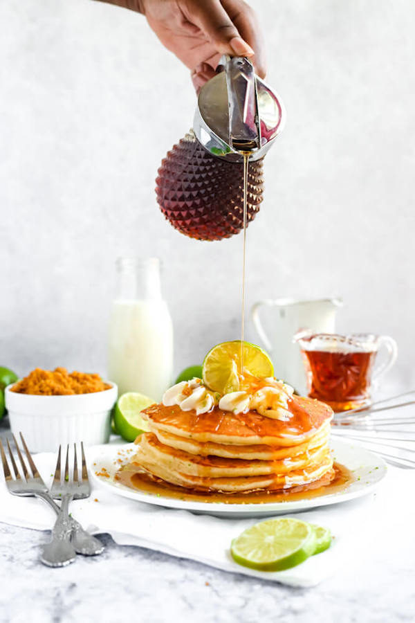 lime pancakes with whipped cream, graham cracker crumbs, lime zest and a lime twist on top