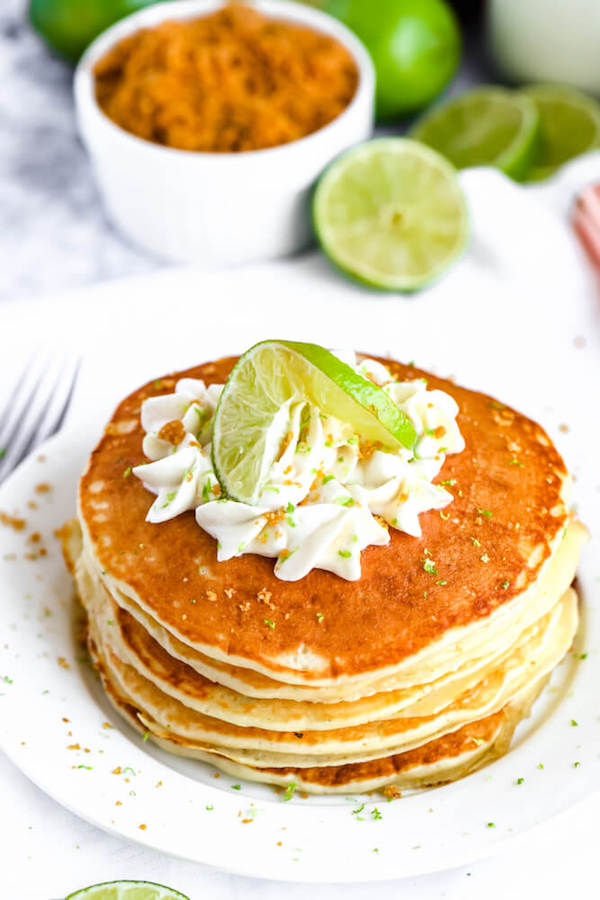 lime pancakes with whipped cream, graham cracker crumbs, lime zest and a lime twist on top