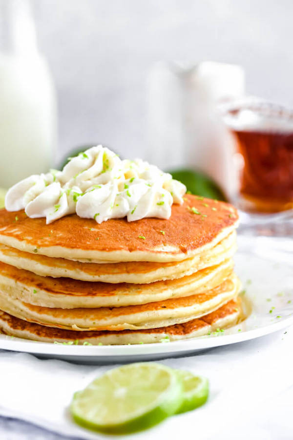 lime pancakes with whipped cream, graham cracker crumbs, lime zest and a lime twist on top