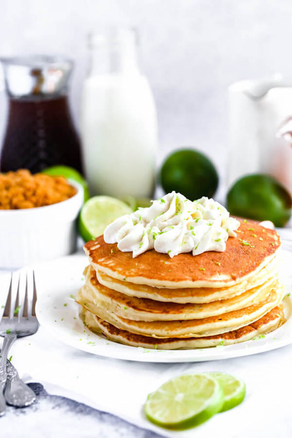 lime pancakes with whipped cream, graham cracker crumbs, lime zest and a lime twist on top