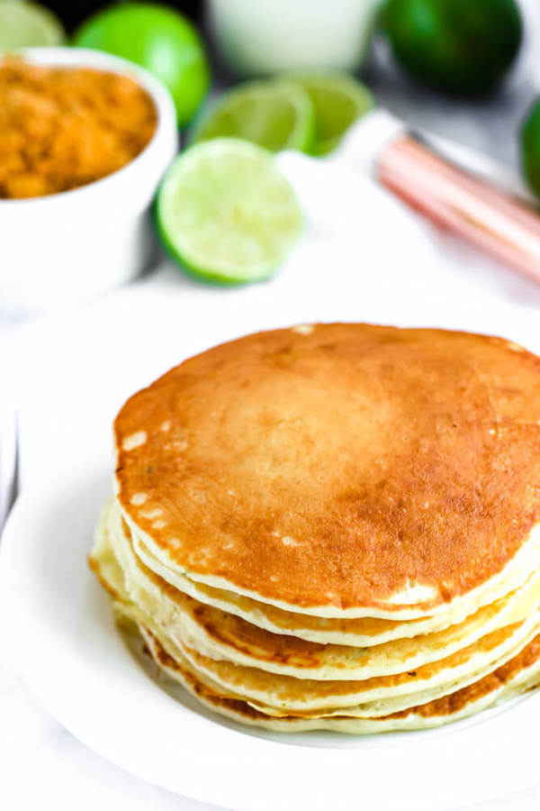 lime pancakes with whipped cream, graham cracker crumbs, lime zest and a lime twist on top