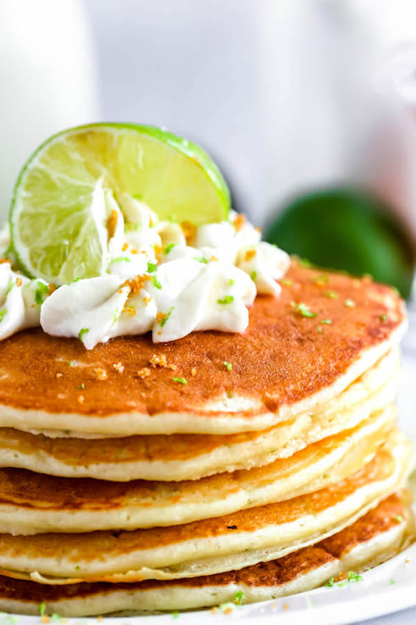 lime pancakes with whipped cream, graham cracker crumbs, lime zest and a lime twist on top