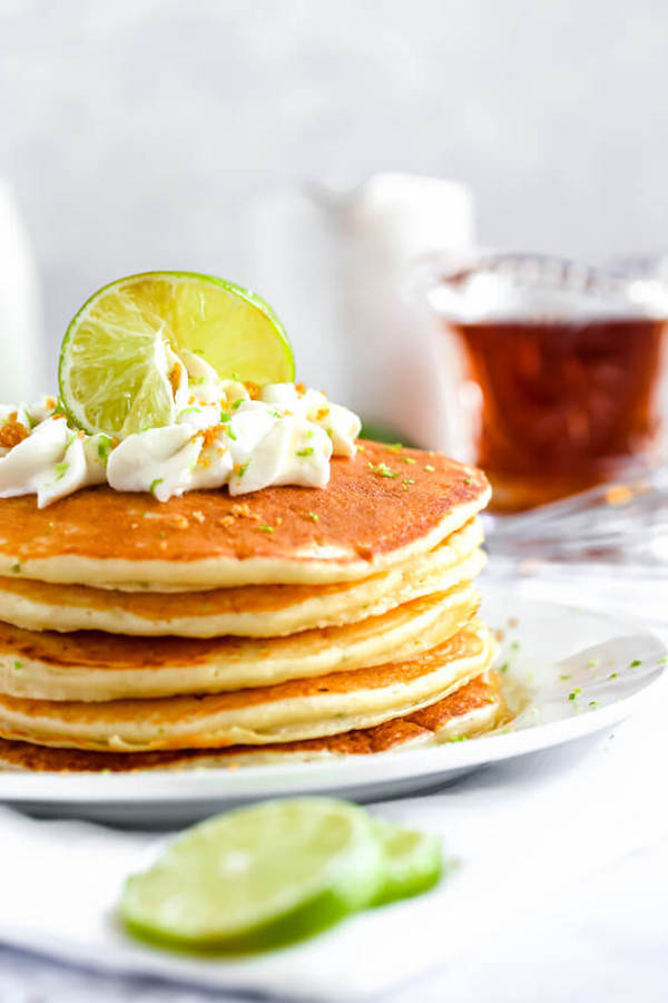 lime pancakes with whipped cream, graham cracker crumbs, lime zest and a lime twist on top