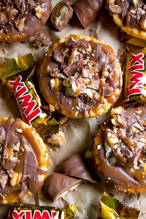 These Mini Twix Tarts taste just like a Twix bar! Mini pre-baked tart shells filled with homemade caramel sauce and topped with milk chocolate and chopped Twix bars. If you love Twix candy bars then this is the perfect treat for you!