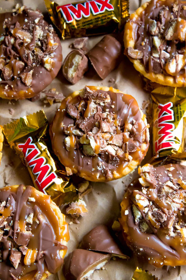 These Mini Twix Tarts taste just like a Twix bar! Mini pre-baked tart shells filled with homemade caramel sauce and topped with milk chocolate and chopped Twix bars. If you love Twix candy bars then this is the perfect treat for you!