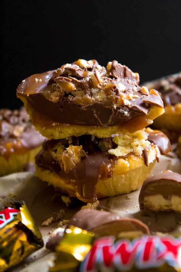 These Mini Twix Tarts taste just like a Twix bar! Mini pre-baked tart shells filled with homemade caramel sauce and topped with milk chocolate and chopped Twix bars. If you love Twix candy bars then this is the perfect treat for you!