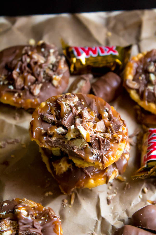 These Mini Twix Tarts taste just like a Twix bar! Mini pre-baked tart shells filled with homemade caramel sauce and topped with milk chocolate and chopped Twix bars. If you love Twix candy bars then this is the perfect treat for you!