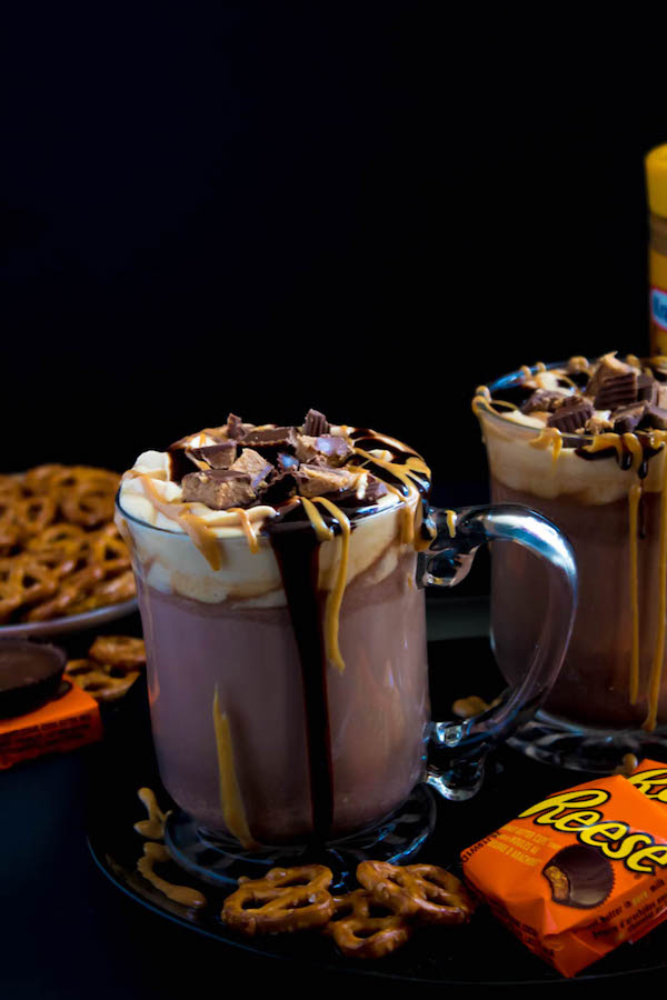 This quick and easy Peanut Butter Hot Chocolate tastes just like a peanut butter cup in liquid form! Top it off with peanut butter whipped cream, chopped peanut butter cups, and a drizzle of chocolate sauce and melted peanut butter for the ultimate PB and Chocolate drink!