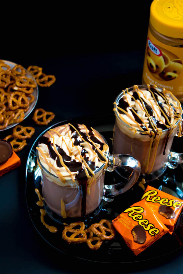 This quick and easy Peanut Butter Hot Chocolate tastes just like a peanut butter cup in liquid form! Top it off with peanut butter whipped cream, chopped peanut butter cups, and a drizzle of chocolate sauce and melted peanut butter for the ultimate PB and Chocolate drink!