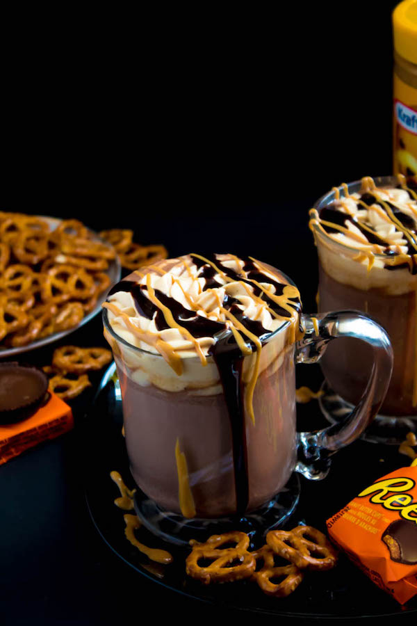 This quick and easy Peanut Butter Hot Chocolate tastes just like a peanut butter cup in liquid form! Top it off with peanut butter whipped cream, chopped peanut butter cups, and a drizzle of chocolate sauce and melted peanut butter for the ultimate PB and Chocolate drink!