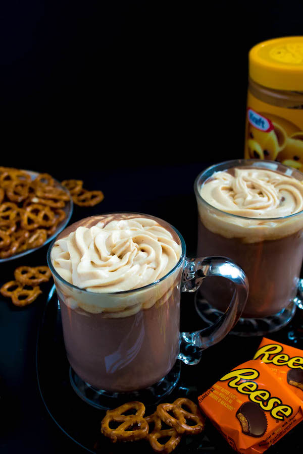 This quick and easy Peanut Butter Hot Chocolate tastes just like a peanut butter cup in liquid form! Top it off with peanut butter whipped cream, chopped peanut butter cups, and a drizzle of chocolate sauce and melted peanut butter for the ultimate PB and Chocolate drink!