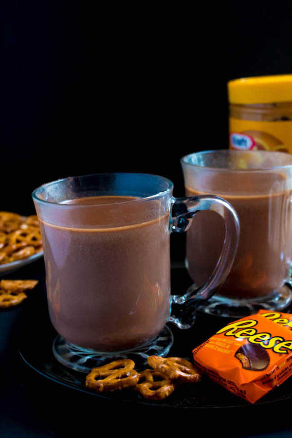This quick and easy Peanut Butter Hot Chocolate tastes just like a peanut butter cup in liquid form! Top it off with peanut butter whipped cream, chopped peanut butter cups, and a drizzle of chocolate sauce and melted peanut butter for the ultimate PB and Chocolate drink!