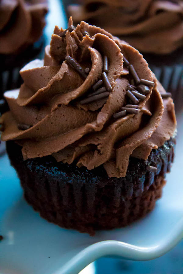 These Chocolate Cupcakes are perfectly moist, fluffy and full of rich chocolate flavour! Topped with a silky and dreamy Chocolate Buttercream Frosting - these cupcakes are the perfect treat for chocoholics.