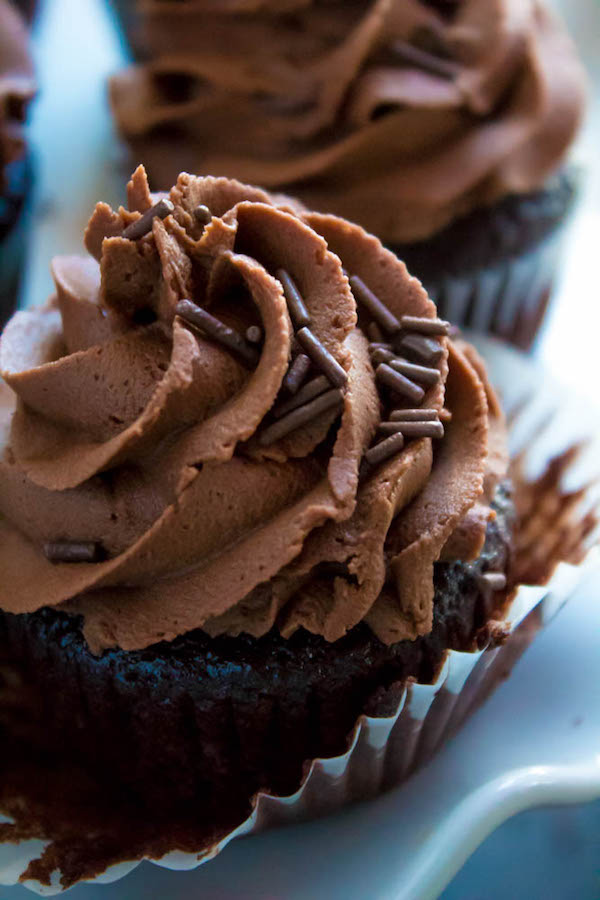 These Chocolate Cupcakes are perfectly moist, fluffy and full of rich chocolate flavour! Topped with a silky and dreamy Chocolate Buttercream Frosting - these cupcakes are the perfect treat for chocoholics.