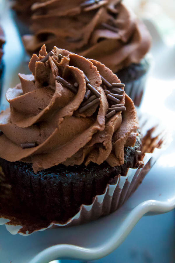 These Chocolate Cupcakes are perfectly moist, fluffy and full of rich chocolate flavour! Topped with a silky and dreamy Chocolate Buttercream Frosting - these cupcakes are the perfect treat for chocoholics.