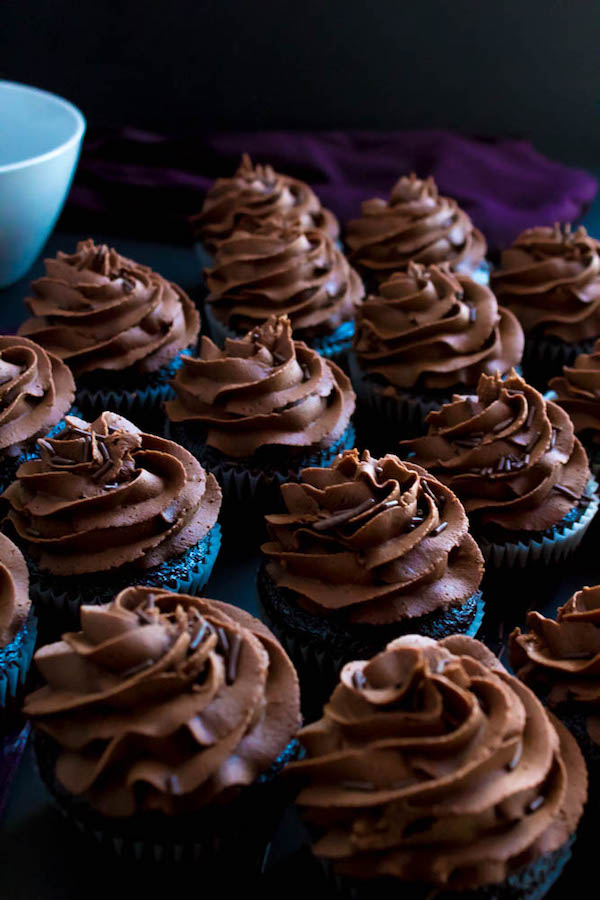 These Chocolate Cupcakes are perfectly moist, fluffy and full of rich chocolate flavour! Topped with a silky and dreamy Chocolate Buttercream Frosting - these cupcakes are the perfect treat for chocoholics.
