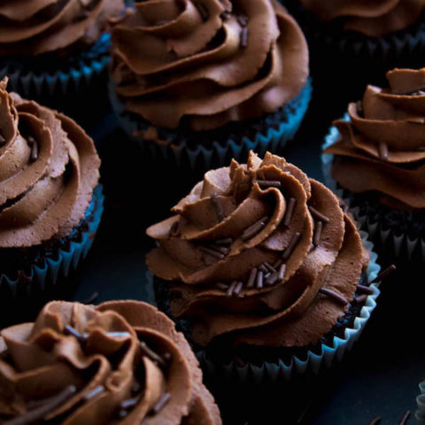 These Chocolate Cupcakes are perfectly moist, fluffy and full of rich chocolate flavour! Topped with a silky and dreamy Chocolate Buttercream Frosting - these cupcakes are the perfect treat for chocoholics.