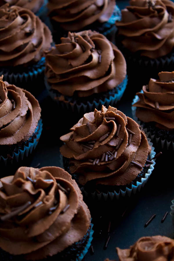 These Chocolate Cupcakes are perfectly moist, fluffy and full of rich chocolate flavour! Topped with a silky and dreamy Chocolate Buttercream Frosting - these cupcakes are the perfect treat for chocoholics.