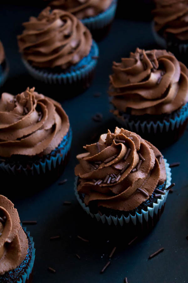 These Chocolate Cupcakes are perfectly moist, fluffy and full of rich chocolate flavour! Topped with a silky and dreamy Chocolate Buttercream Frosting - these cupcakes are the perfect treat for chocoholics.