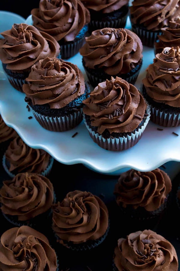 These Chocolate Cupcakes are perfectly moist, fluffy and full of rich chocolate flavour! Topped with a silky and dreamy Chocolate Buttercream Frosting - these cupcakes are the perfect treat for chocoholics.