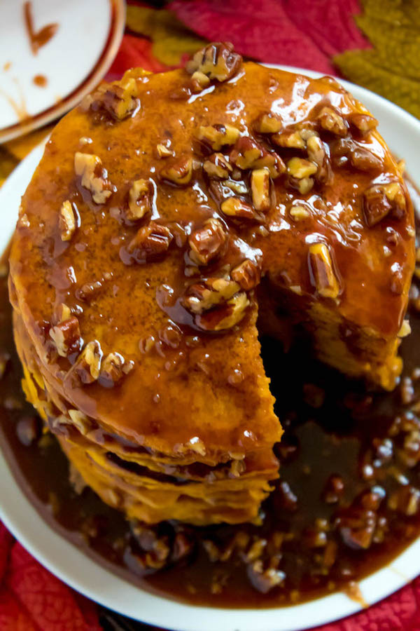 These Pumpkin Pancakes are light, fluffy and has the perfect amount of pumpkin and spice flavour! Topped with a rich and delicious Maple Pecan Praline Syrup, these irresistible pancakes are the perfect fall breakfast!