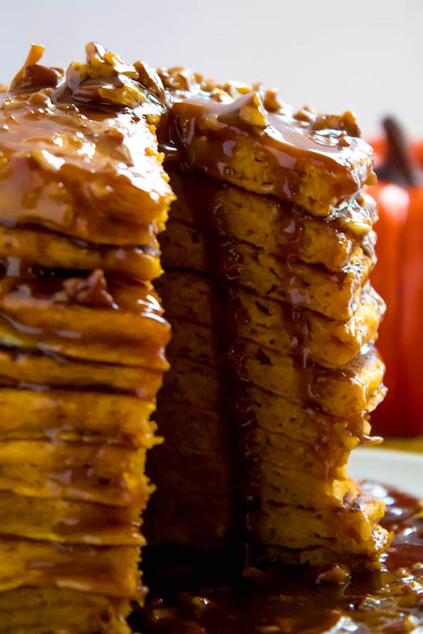 These Pumpkin Pancakes are light, fluffy and has the perfect amount of pumpkin and spice flavour! Topped with a rich and delicious Maple Pecan Praline Syrup, these irresistible pancakes are the perfect fall breakfast!