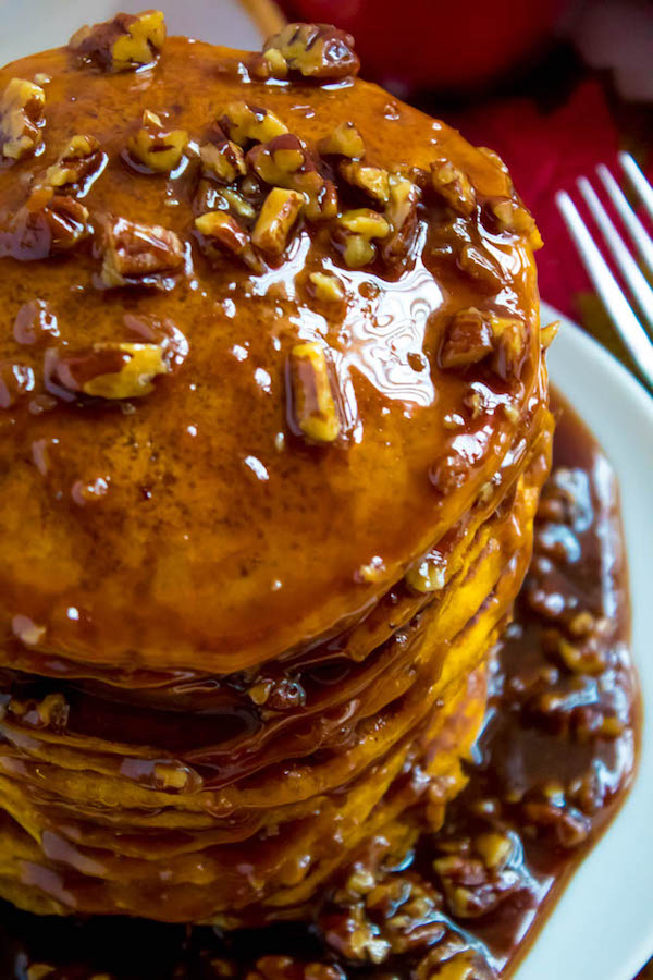 These Pumpkin Pancakes are light, fluffy and has the perfect amount of pumpkin and spice flavour! Topped with a rich and delicious Maple Pecan Praline Syrup, these irresistible pancakes are the perfect fall breakfast!