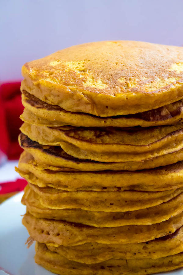 These Pumpkin Pancakes are light, fluffy and has the perfect amount of pumpkin and spice flavour! Topped with a rich and delicious Maple Pecan Praline Syrup, these irresistible pancakes are the perfect fall breakfast!