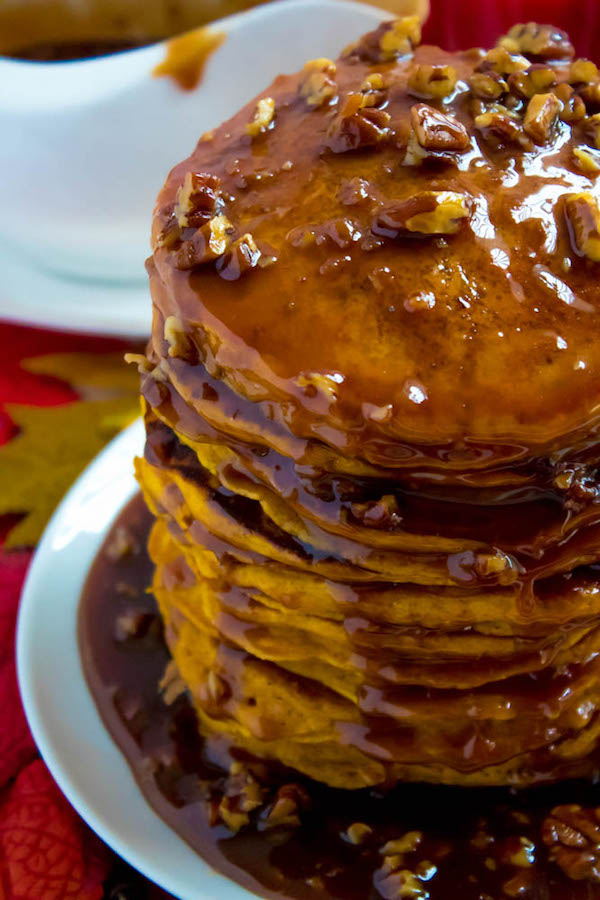 These Pumpkin Pancakes are light, fluffy and has the perfect amount of pumpkin and spice flavour! Topped with a rich and delicious Maple Pecan Praline Syrup, these irresistible pancakes are the perfect fall breakfast!