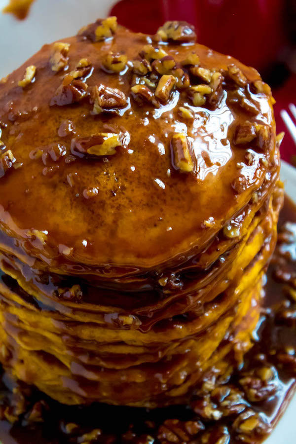These Pumpkin Pancakes are light, fluffy and has the perfect amount of pumpkin and spice flavour! Topped with a rich and delicious Maple Pecan Praline Syrup, these irresistible pancakes are the perfect fall breakfast!